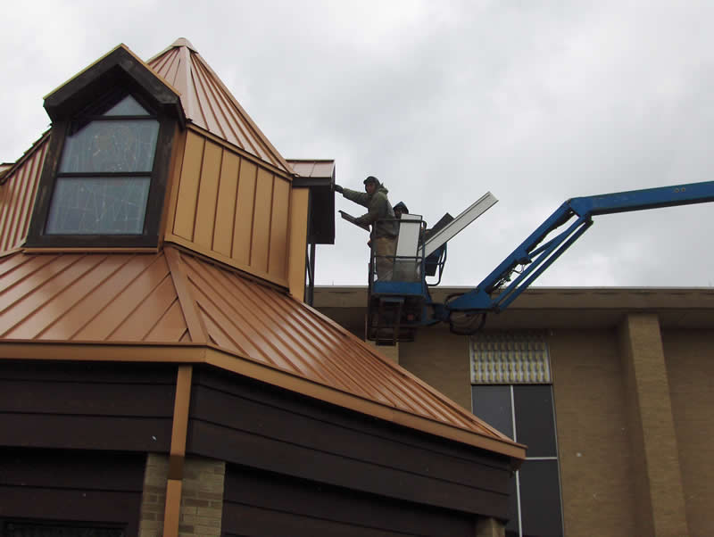 Photo of a man working on a roof.